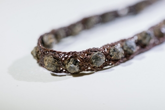 Tin-studded armband or bracelet found at Whitehorse Hill archaeological site.