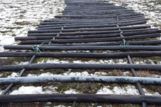 Sturdy floating “road” or bog mat made from recycled salmon farm cage frames