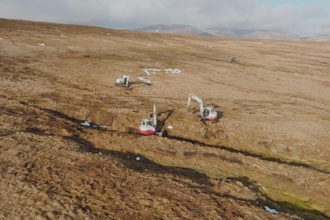 Aerial view of three machine operators undertaking peatland restoration at Wemyss and March Estates