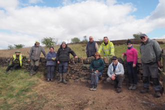 Friends of Crompton Moor volunteers with newly built dry stone wall