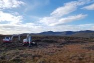 Two machine operators restoring the peatland at Pennant Farm, Wales