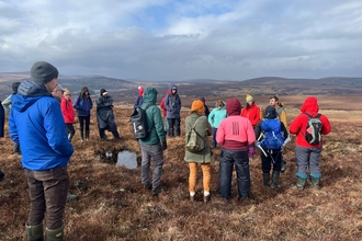 Group of people on a site visit to a peatland.
