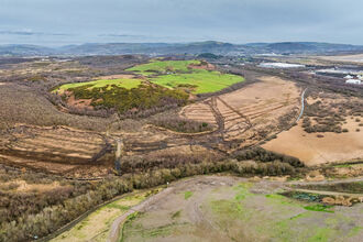 Aerial view of Crymlyn Bog with Swansea University Bay Campus and Swansea Bay in the distance.