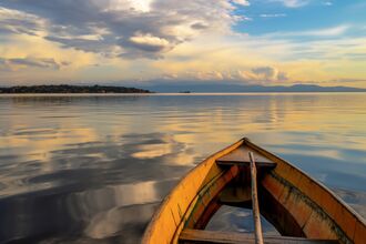 View of a large lake from an open canoe.