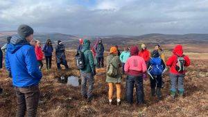 Group of people on a site visit to a peatland.