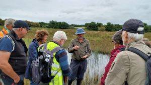 Dr Peter Jones sharing his peatland expertise and passion on an Eisteddfod-linked visit to Cors Geirch in collaboration with Cymdeithas Edward Llwyd (Welsh natural history group).