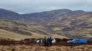 Group of people stood in an open peatland landscape 