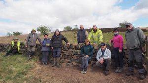 Volunteer group with newly built dry stone wall