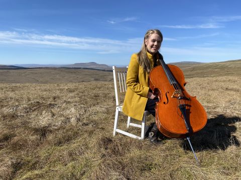 Musician Sarah Smouth on Fleet Moss with her cello