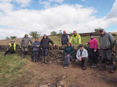 Volunteers with newly built dry stone wall