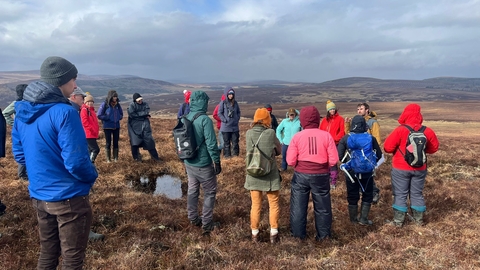 Group of people on a site visit to a peatland.