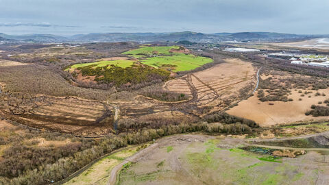 Aerial view of Crymlyn Bog with Swansea University Bay Campus and Swansea Bay in the distance.