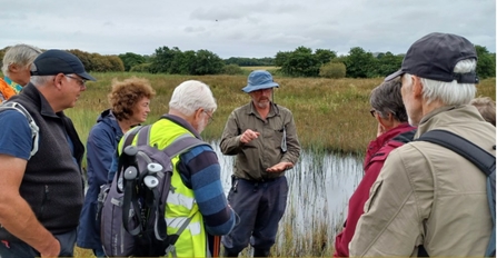 Dr Peter Jones sharing his peatland expertise to a group of people on an Eisteddfod-linked visit to Cors Geirch in collaboration with Cymdeithas Edward Llwyd (Welsh natural history group). Credit Natural Resources Wales.