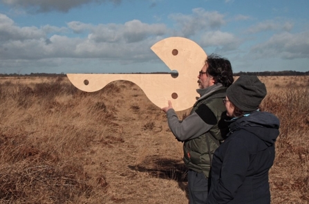 Keith Ashford and Liz Turner test out a sculptural design for “Centre Finder” at Whixall Moss