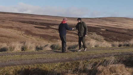 Rachel Coyle (Tweed Forum Peatland ACTION project officer) and Martin Andrews (Wemyss & March Estates) shaking hands to greet each other 