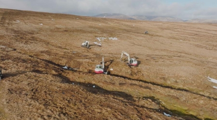 Aerial view of three machine operators undertaking peatland restoration at Wemyss and March Estates