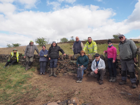  Friends of Crompton Moor volunteers with newly built dry stone wall