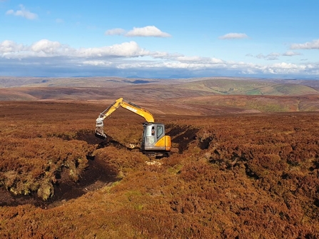 Machine operator reprofiling a gully Pennine PeatLIFE