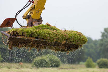Close up of a digger harvesting Sphagnum