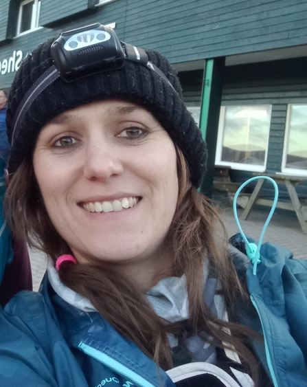 Rochelle in outdoor clothing with a headtorch