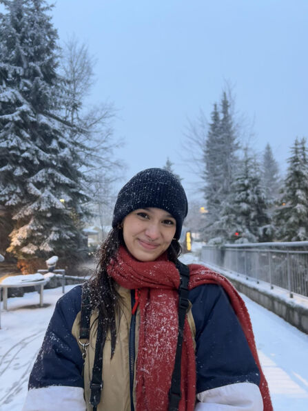 Nadia Murphy smiling at the camera, wearing warm hat, coat and scarf.