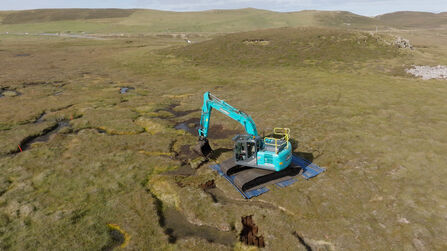 Aerial view of a low ground pressure excavator on an area of damaged peatland.