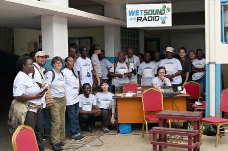 Group of people wearing grey t-shirts with the words 'Actioning Venice Agreement'.