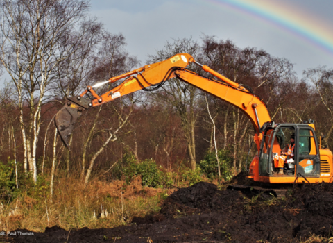 Machine operator undertaking peatland restoration at Risley Moss