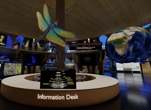 A virtual information desk with a large dragonfly suspended above it and a floating globe to the right of the desk.